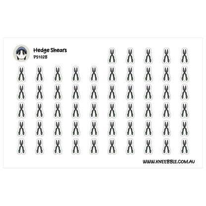 a grid of small black and white stickers, each depicting a pair of scissors. The stickers are arranged in rows and columns, creating a visually organized and repetitive pattern.