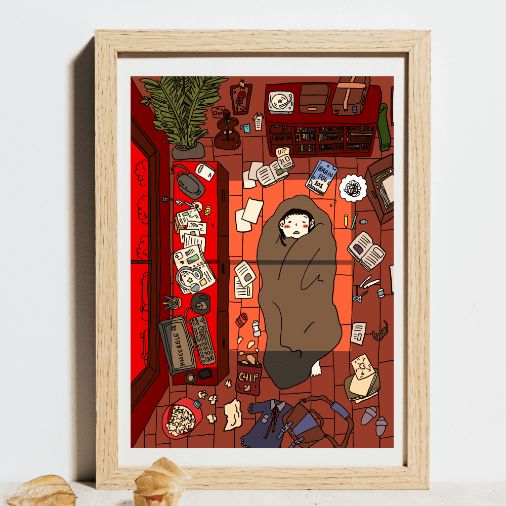 Framed art print featuring a hand-drawn digital illustration of a cozy, cluttered room with a person wrapped in a blanket lying on the floor. The scene captures a day of relaxation and creativity, with various items scattered around, including books, snacks, and art supplies, set against a warm red backdrop.